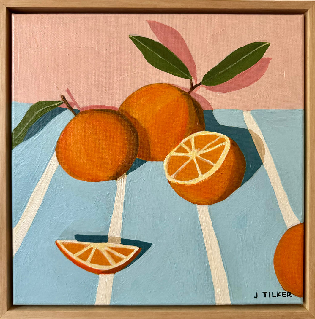 “Oranges on a striped tablecloth